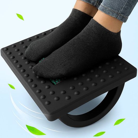 Person using a footrest with black socks on a light blue background